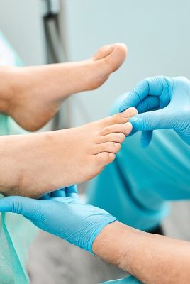 Close up portrait of female feet on the medical chair while doctor podiatrist treatment nail with modern medical technologies in beauty clinic